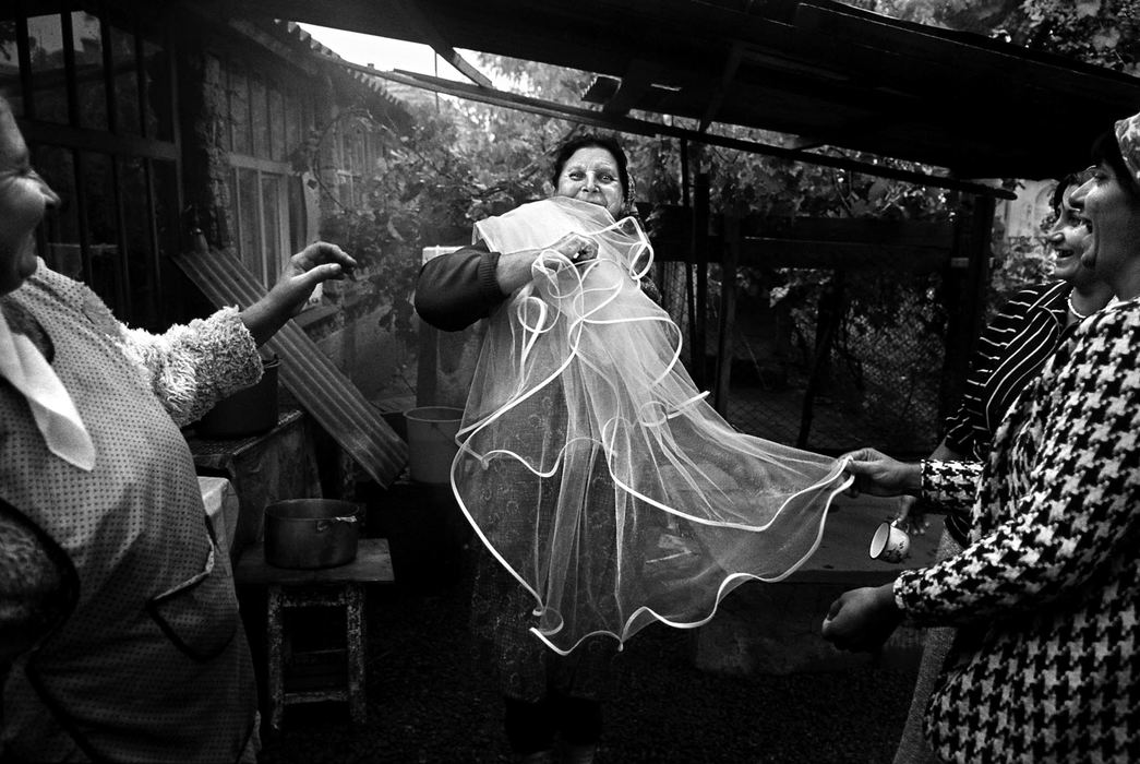 Second Place, Photographer of the Year - Greg Ruffing / FreelanceWomen take turns dancing with the bride's veil during a wedding party. A Roma wedding celebration can last for several days before and after the actual ceremony, as this is a time of jovial dancing, singing, drinking and bonding.