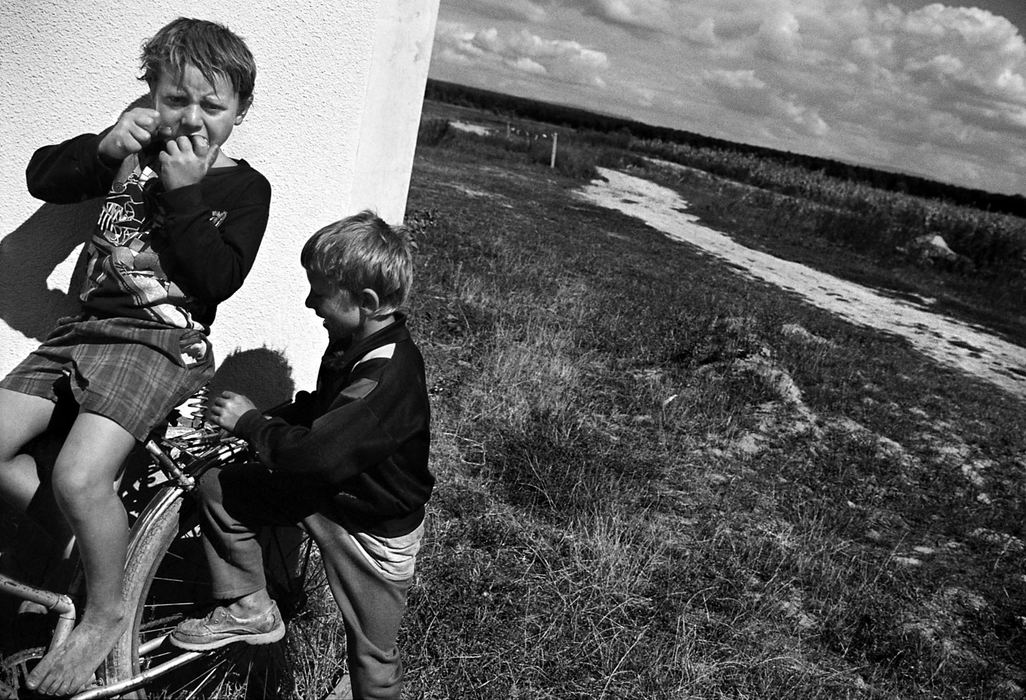 Second Place, Photographer of the Year - Greg Ruffing / FreelanceTwo young boys play on an old bicycle. Some Roma children spend their days playing in the village because their parents cannot afford to send them to school or because they are denied access to certain schools.