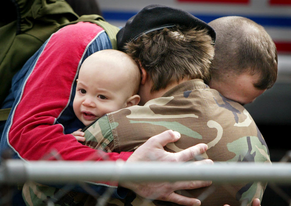 Third Place, Photographer of the Year - Fred Squillante / The Columbus DispatchMandi Balla, center, shares a final embrace with her husband Sam, and their 8-month-old son, Logan, after being mobilized for the Middle East. Mandi, an Army reservist, is not scared the most by war with Iraq. She fears Logan won't know his mother when she arrives home.