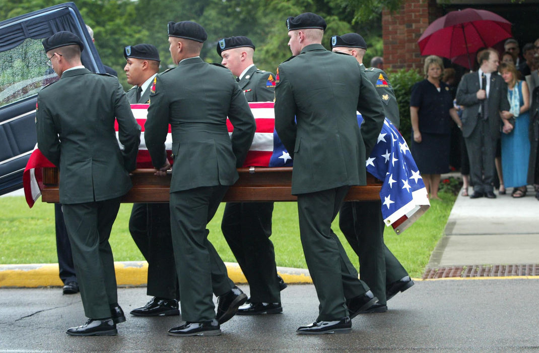 Third Place, Photographer of the Year - Fred Squillante / The Columbus DispatchThe casket bearing the body of Pfc. Branden F. Oberleitner is put into the hearse after funeral services at Worthington United Methodist Church. At right are his stepfather and mother, Frank and Iris Carmack. Oberleitner, 20, became the second man with ties to Franklin County to be killed in Iraq when a rocket-propelled grenade was fired at U.S. soldiers at an Army checkpoint. 