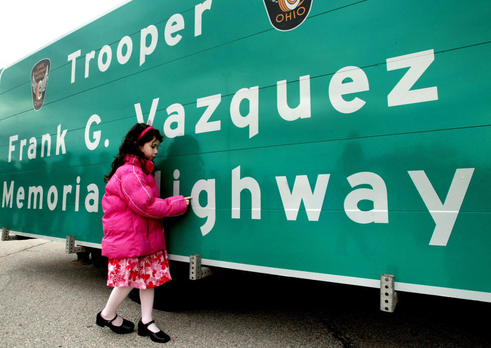 Third Place, Photographer of the Year - Fred Squillante / The Columbus DispatchKyra Vazquez, 4, uses her finger to trace the letters on a highway sign honoring her father, Ohio State Highway Patrol officer Frank G. Vazquez, who was struck and killed by a drunken driver Nov. 5, 2001. Vazquez was working special duty on I-270 when he was struck. I-270, between I-70 and Georgesville Rd. has been declared Trooper Frank G. Vazquez Memorial Highway.  Kyra attended a dedication ceremony with her mom, Kristina, and her brothers Christian, 6, and Noah, 2. 