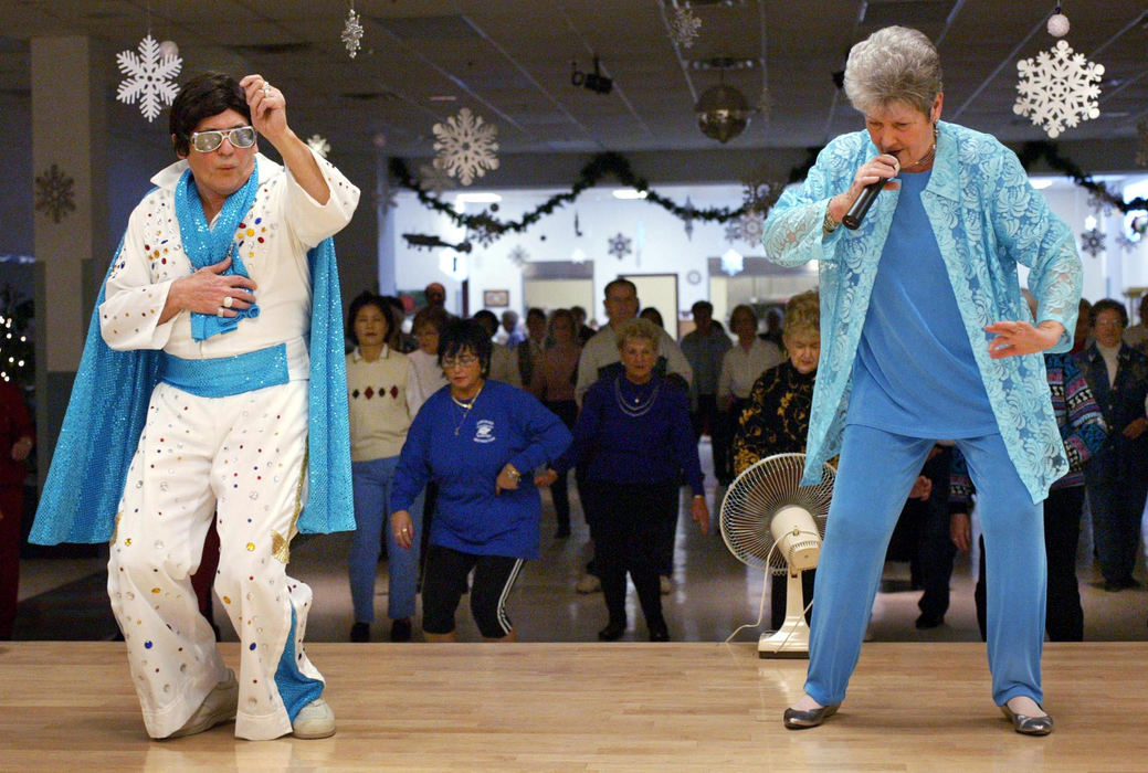 Third Place, Photographer of the Year - Fred Squillante / The Columbus DispatchDon Hamilton, 70, left, and his wife, Jean, 74, lead seniors in a line dancing class at Gillie Senior Center in Columbus. Don, dressed as Elvis, and Jean entertain at other senior centers and nursing homes. Don also dresses as John Travolta. They work as volunteers and for donations.