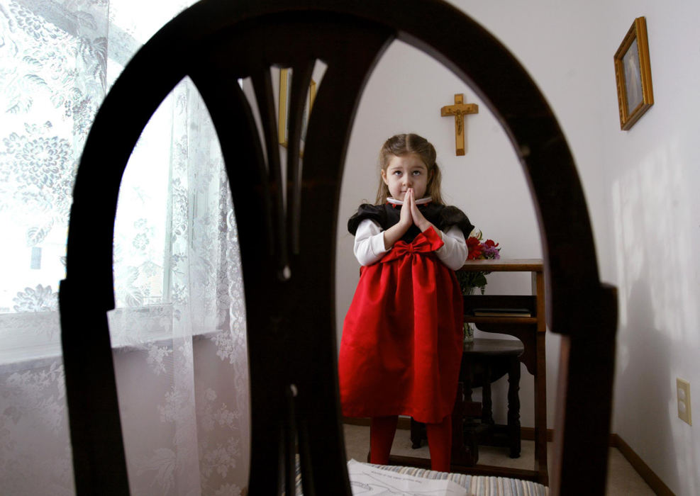 Third Place, Photographer of the Year - Fred Squillante / The Columbus DispatchIsabella Gessler, 4,  stands in her family's home chapel. Isabella's mother, Mariely Elisa, decided to create the small chapel and alter in their home; she has seen the effect the chapel has on her children. "I think it is also good for the children, just to come and be still," she said.