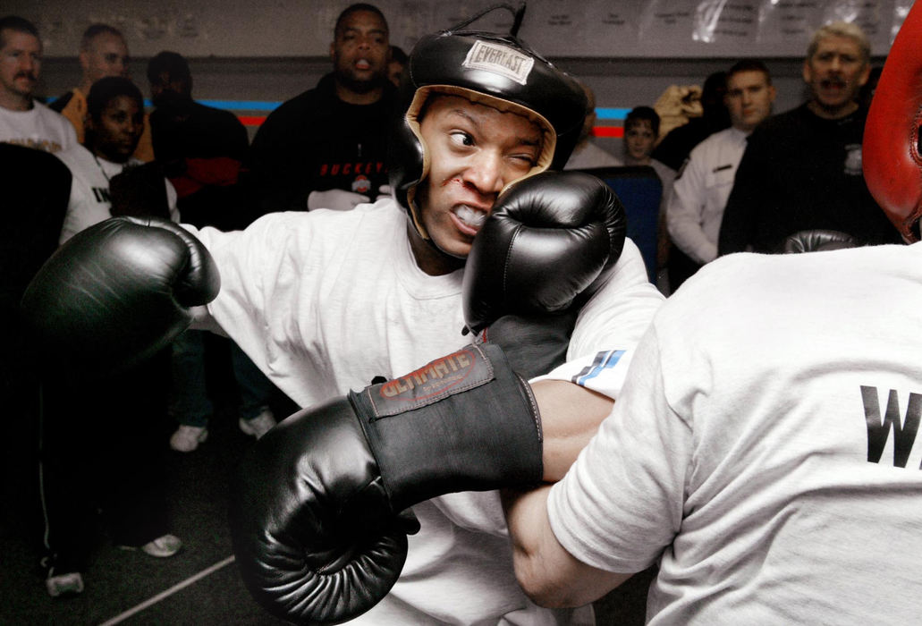 Third Place, Photographer of the Year - Fred Squillante / The Columbus DispatchColumbus police recruit Rashawn Sykes, left, trades punches with colleague Charles Waldenga during boxing competition at the police training academy. Boxing is part of their training; recruits learn not to quit when they are hit. Officer Joe Smith, a 30-year veteran and Columbus police boxing instructor said, "Some (recruits) get hit in the nose and want to stop. You have to have a no-quit attitude."