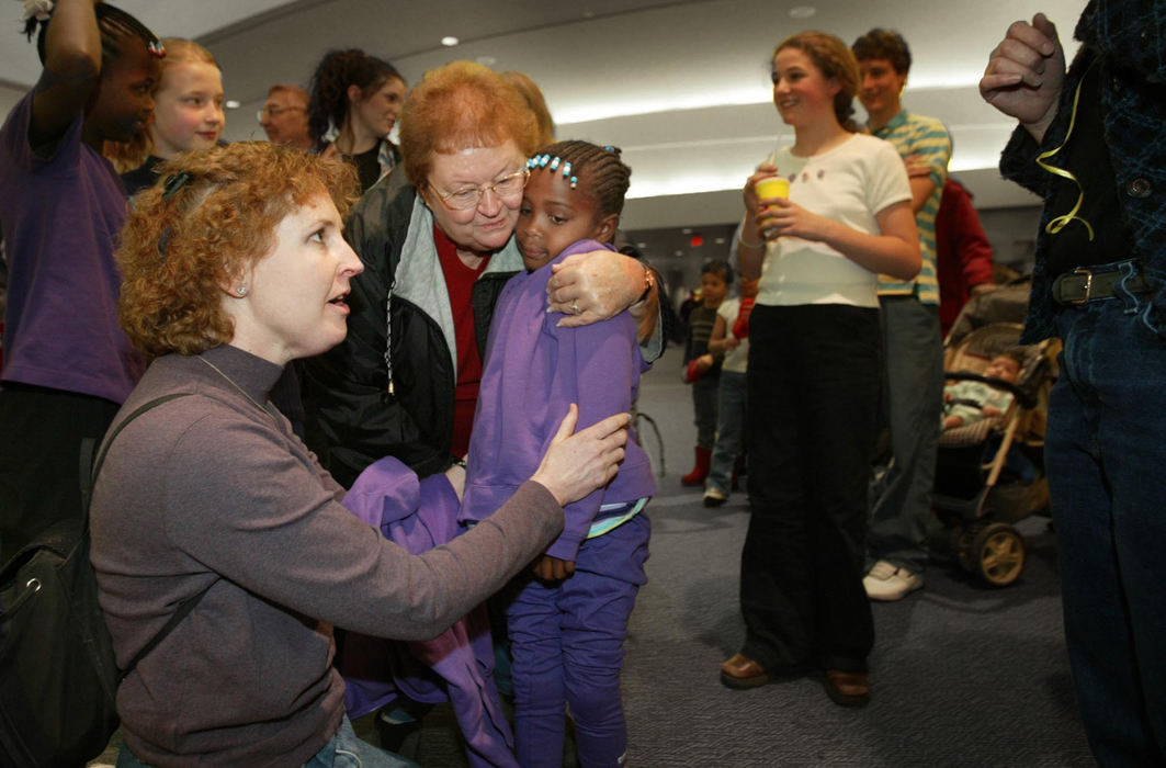 Third Place, Photographer of the Year - Fred Squillante / The Columbus DispatchKristian (center) gets a hug from her new grandmother, Barb Edison, after arriving in Columbus. At left is Robyn Baden. 