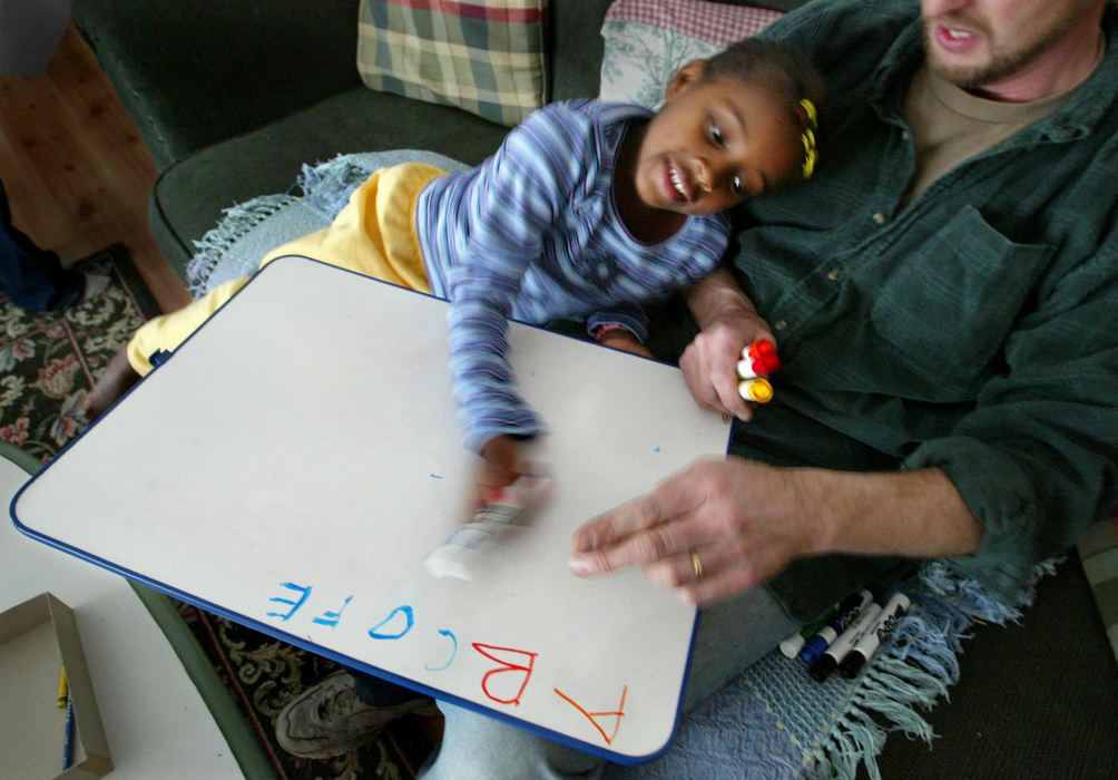 Third Place, Photographer of the Year - Fred Squillante / The Columbus DispatchKristian writes her ABC's in the Baden home with dad, Jim. 