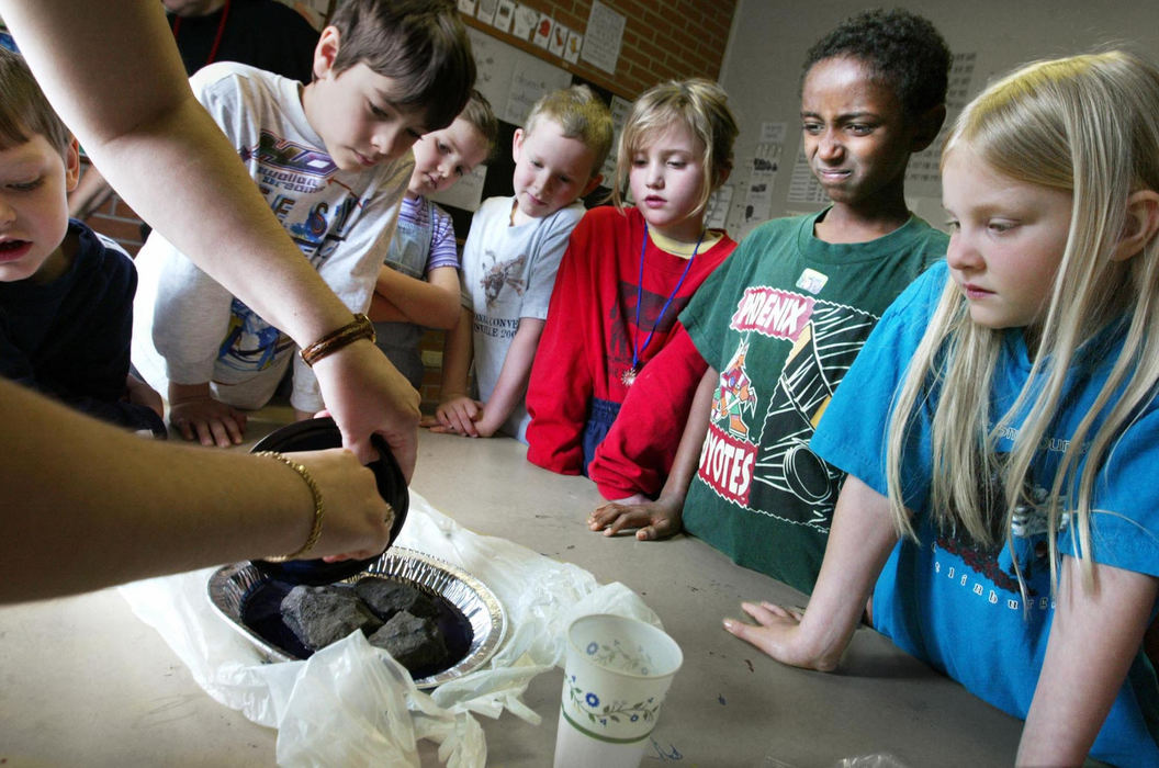 Third Place, Photographer of the Year - Fred Squillante / The Columbus DispatchWasihun Baden, second from right, grimmaces as teacher Lora Davis  mixes liquids to grow crystals during a science experiment  at Johnstown Home School.