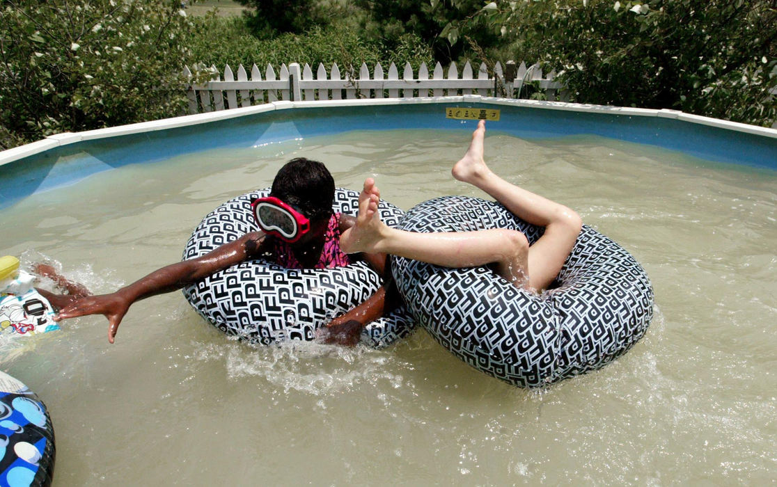 Third Place, Photographer of the Year - Fred Squillante / The Columbus DispatchAgernesh, left, and sister Caroline, right, play in the family pool on a hot summer day. 