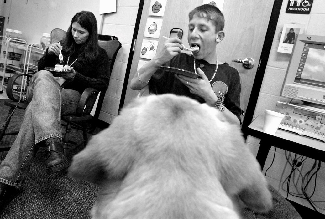 Third Place, Photographer of the Year - Fred Squillante / The Columbus DispatchEven though Foreman got a special doggie treat earlier, he only could look on as Charlie Slane, right, and Walnut Springs Middle School teacher Amy DuBois, left,  eat their birthday cake during a celebration of the two-year anniversary of the Kids and Canines program.