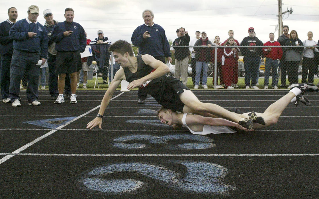 First Place, Sports Action - Scott R. Galvin / The VindicatorShane Harding of Salem topples over Vinny Freedman of Howland High just shy of the finish of the 1,600 meter run in the Metro Athletic Conference Championships.  Harding crawled across the line to win; Freedman was disqualified for interference.