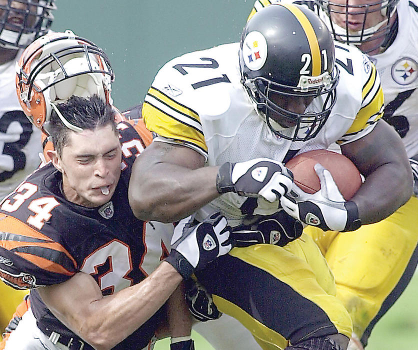 Award of Excellence, Sports Action - James E. Mahan / Urbana Daily CitizenThe Bengals Kevin Kaesviharn has his helmet knocked off as he tackles Amos Zereoue of the Pittsburgh Steelers.