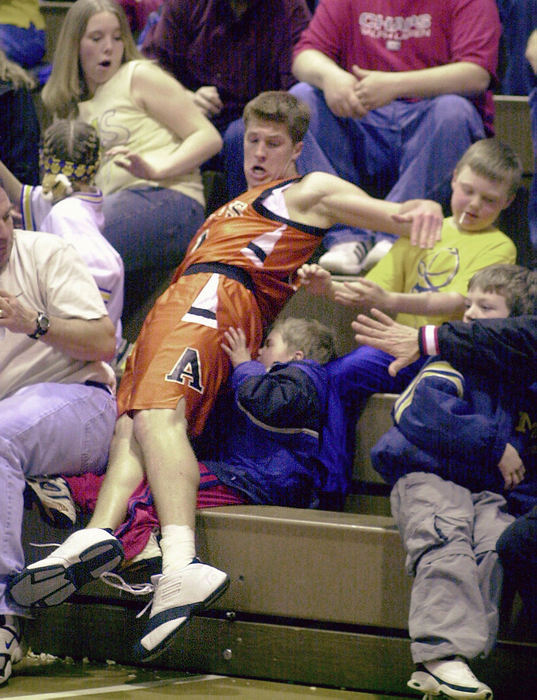 Award of Excellence, Sports Feature - Dave Polcyn / The News JournalAshland's Adam Hawks manages to avoid crashing into five-year-old Sam Hickey of Findlay after saving a ball from going out of bounds during their district basketball final against Findlay.