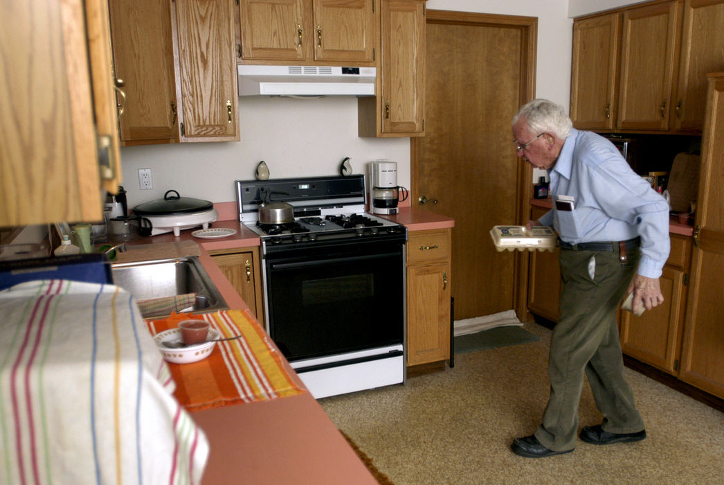 First Place, Student Photographer of the Year - Haraz Ghanbari / Kent State UniversityBrief Overview: 91-year-old Dudley Shaw and his wife Evelyn were married in 1936. In 1992 Evelyn was diagnosed with Alzheimer's Disease and for the last ten years has been confined to her bed. Dudley refuses to put his wife in a nursing home and spends his time taking care of her in their North Ridgeville, home. Although Evelyn can not talk and has very limited movement, Dudley has an undying love for his wife of 68 years.Dudley Shaw, 91, prepares to make breakfast for his 90-year-old wife Evelyn.