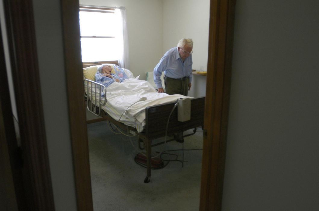 First Place, Student Photographer of the Year - Haraz Ghanbari / Kent State UniversityDudley Shaw leaves the room after checking on his wife Evelyn, Dec. 27, 2003 in North Ridgeville. Evelyn was diagnosed with Alzheimer's Disease in 1992, and Dudley spends his days taking care of her at their home. 