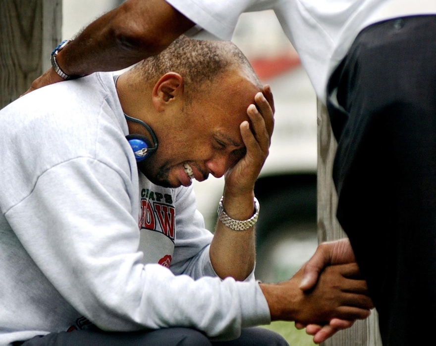 First Place, Student Photographer of the Year - Haraz Ghanbari / Kent State UniversityDwyane Ford is consoled after learning about the fire at his mother's house that killed his aunt and sent his 8-year-old cousin to the hospital, June 16, 2003 in Columbus. 