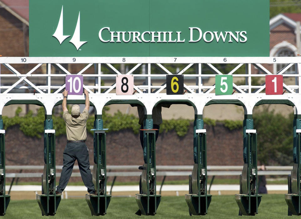 Second Place, Student Photographer of the Year - Scott R. Galvin / Kent State UniversityA Chuchill Downs track worker changes the starting-gate numbers after a horse scratched from the upcoming race April 26, 2003 in Louisville, KY.