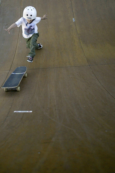 Second Place, Student Photographer of the Year - Scott R. Galvin / Kent State UniversityDylan Oliver is a five year old skateboarder with five sponsors and is a natural on a skateboard.  Word around the skate parks of Louisville, Kentucky, is that Dylan will be the next Tony Hawk of skateboarding.  He has only been skating for 18 months, but rarely misses a day to practice.Dylan chases his skateboard up the half-pipe at the Extreme Park after losing the board from under his feet.