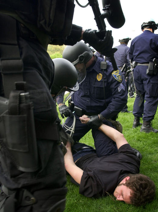 First Place, Student Photographer of the Year - Haraz Ghanbari / Kent State UniversityA demonstrator is arrested at Kent State University after several hundred anti-war protesters ignored a police order not to march on the public roadway, May 4, 2003, in Kent. 