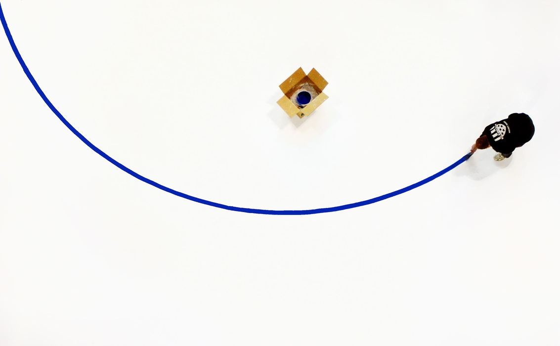 First Place, Student Photographer of the Year - Haraz Ghanbari / Kent State UniversityIce technician Mike Sims paints the center ice circle on the ice at Nationwide Arena in preparation for the upcoming National Hockey League Blue Jackets' season. Sims said that installing new ice takes his crew about 36 hours, a process that includes laying on a new sheet of ice, painting the logos and rink markings, constructing a seal and building a finishing coat.