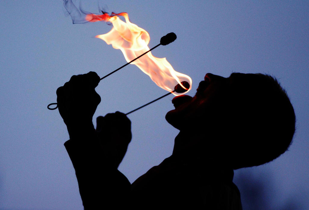 First Place, Student Photographer of the Year - Haraz Ghanbari / Kent State UniversityT. Texas Terry, also known as Terry DaVolt, an entertainer with Brooks and Dunn's Neon Circus and Wild West Show, prepares to eat a fire flame, June 22, 2003 in Columbus. 