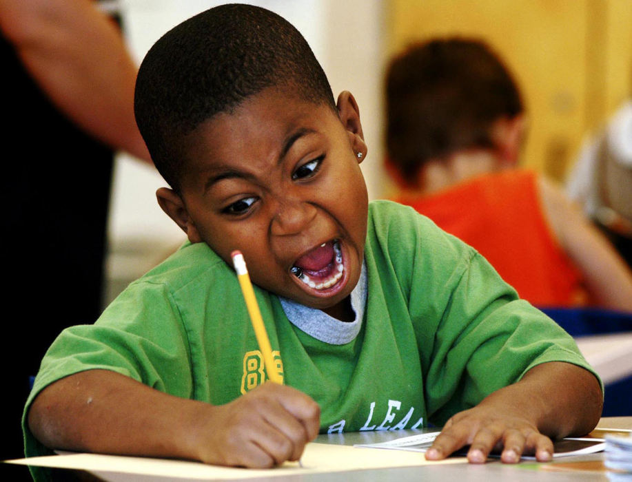 First Place, Student Photographer of the Year - Haraz Ghanbari / Kent State UniversityChristopher Allen-Spiller, 6, sounds out the letters as he completes a sentence about a puppy dog during a writing exercise, August 11, 2003 at Woodcrest Elementary School in Columbus. The exercise was part a reading and language arts class.