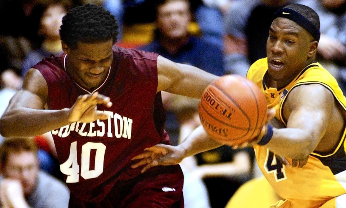 First Place, Student Photographer of the Year - Haraz Ghanbari / Kent State UniversityCollege of Charleston's Thomas Mobley, left, watches as Kent State University's Antonio Gates gets a hand on the ball during the second half in the opening round of the NIT, March 19, 2003 in Kent. College of Charleston beat Kent State 71-66. 