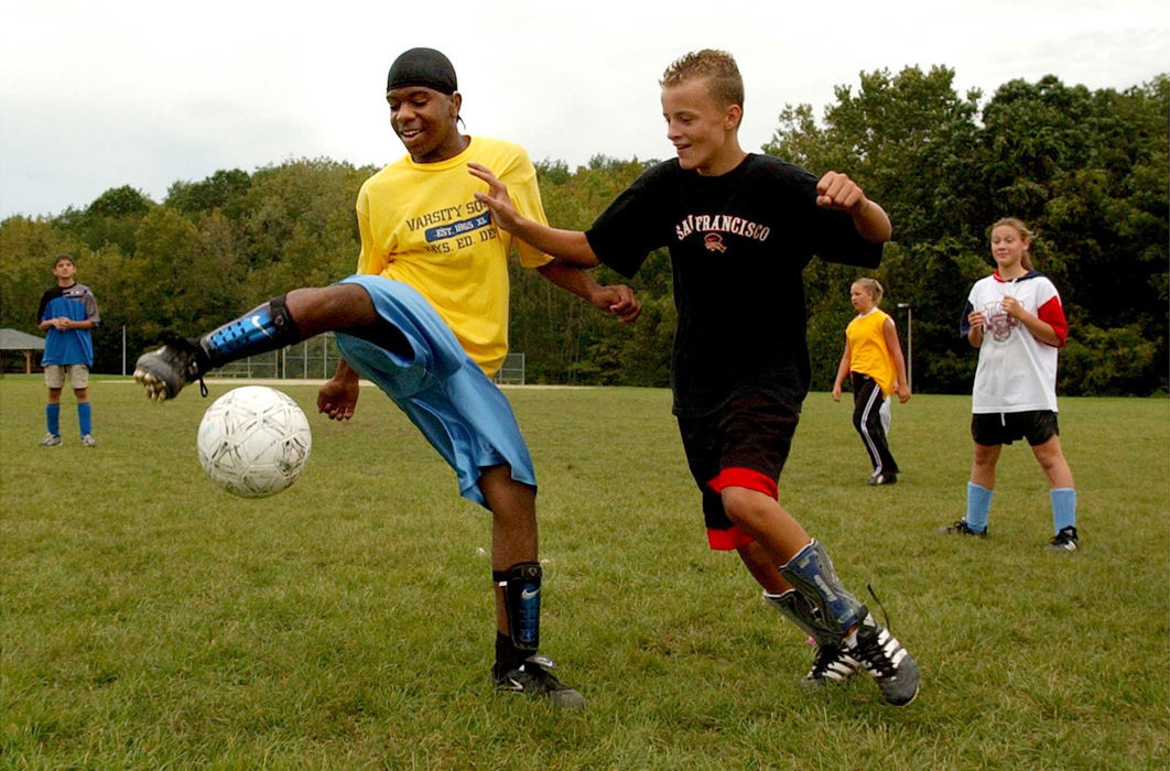 Third Place, Sports Picture Story - David Distelhorst / Akron Beacon JournalHyre Middle School eight-grade students Sandro Hatibovic and Terrel Thomas have a unique bond. Both love the game of soccer and both are secluded from the hearing world due to being deaf. With interpreters inside the classroom and on the playing field both spend much of the day together communicating to each other and the outside world with sign language.  Terrel, left, and Sandro compete for the ball during practice with the Hyre Middle School soccer team. Terrel plays forward and Sandro is a stopper.