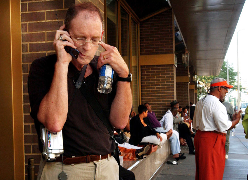 Second Place, Team Picture Story - Marvin Fong / The Plain DealerTim Russell tries to make a phone call to Minnneapolis outside the Sheraton Hotel in downtown Cleveland during the power outage.   Lines were tied up for hours or phones simply failed to work.