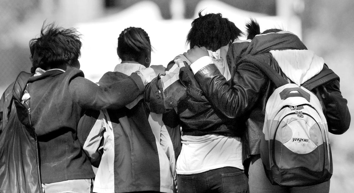 Third Place, Team Picture Story - John Kuntz / The Plain DealerThree students of Nathan Hale Middle School and a woman comfort each other as they walk past the house of classmate Shakira Johnson the day her body was found.