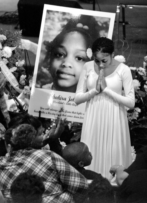 Third Place, Team Picture Story - Roadell Hickman / The Plain DealerA Cleveland School of the Arts dancer pauses after performing in the crowded Mt. Sinai Baptist Church during the funeral of Shakira.  