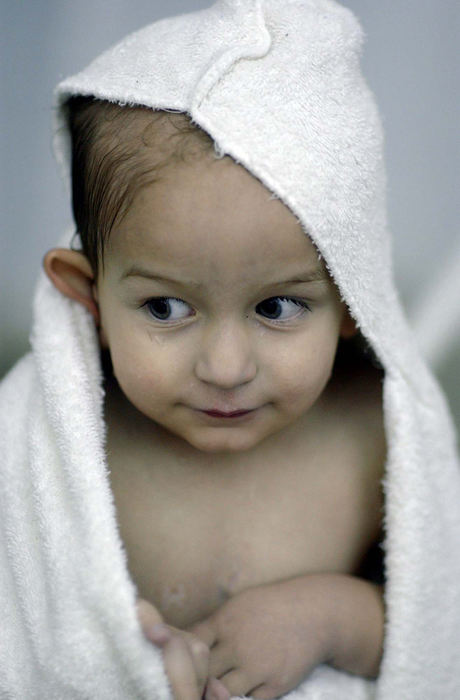 Award of Excellence, Team Picture Story - Daniel Melograna / The News JournalLuke Ervin, 2, wraps himself in a towel as he takes a break from swimming at the Mansfield area YMCA.