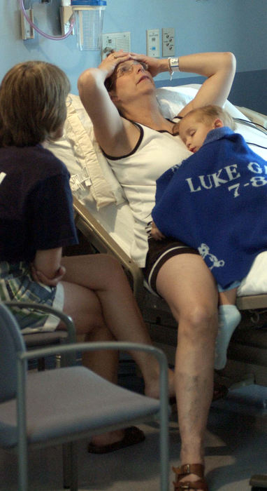 Award of Excellence, Team Picture Story - Daniel Melograna / The News JournalIvy Ervin leans back as she talks with Peggy Lintern, July 15, while her son, Luke, sleeps on her chest at Children's Hospital in Columbus.