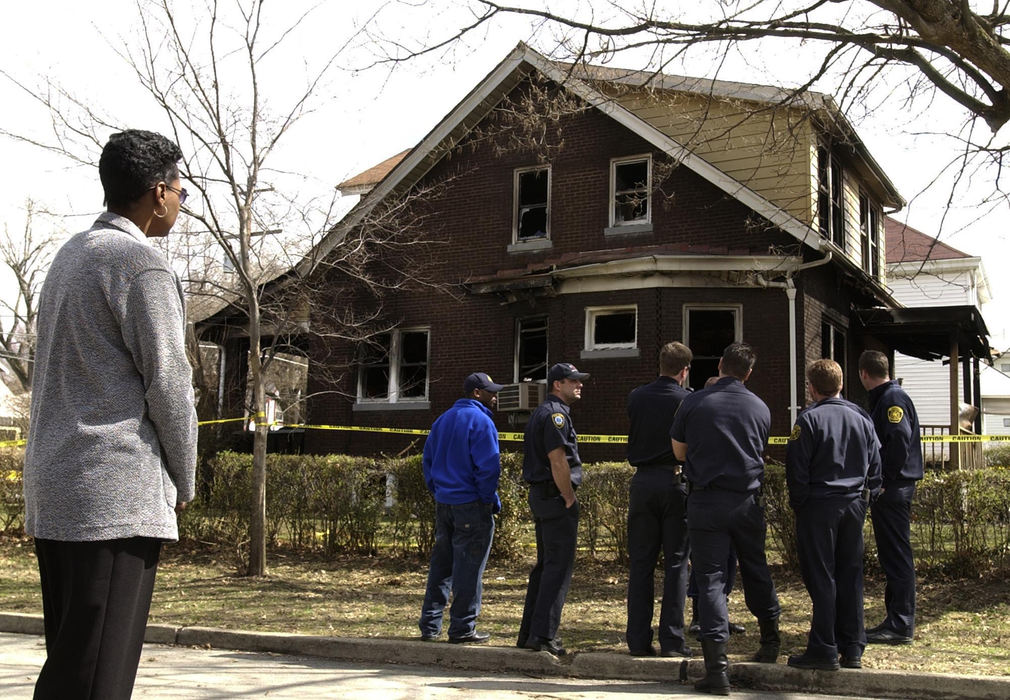 First Place, Team Picture Story - Glenn Hartong / Cincinnati EnquirerOscar Armstrong's mother insisted that she be allowed to see the place where he died. Here,she quietly stands and looks at the house as other firefighters come to the house and do the same.