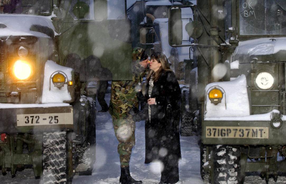 Award of Excellence, War in Iraq - Lynn Ischay / The Plain DealerIn the early morning darkness, Sgt. Gary Murphy of the 372 Maintenance Company of the Ohio Army National Guard kisses his wife, Maureen, goodbye outside the five ton truck he will drive from the Highland Woods Armory. Murphy said this is the first time an Ohio National Guard maintenance unit has been called to active duty since World War II. 