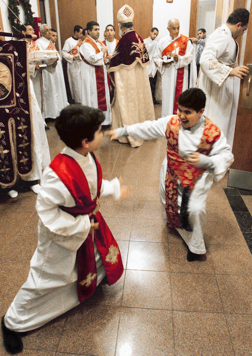 Second Place, Assigned Feature - John Kuntz / The Plain DealerAnthony Abanoub Salama, 9, a deacon at St. Mark Coptic Orthodox Church in Seven Hills enjoys some mock martial arts moves with fellow deacon before the Holy Nativity Divine Liturgy service January 6, 2004. 