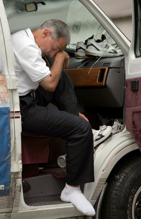 Second Place, Campaign 2004 - Marvin Fong / The Plain DealerDemocratic candidate for U.S. Senate Eric Fingerhut, wipes his face while changing shoes in Mt. Vernon. Fingerhut was looking to defeat incumbent Senator George Voinovich, and had been taking his campaign through a walk across the state.