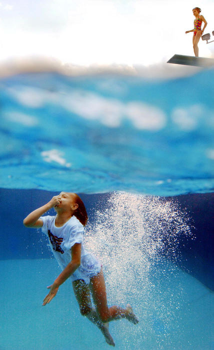 Award of Excellence, Enterprise Feature - John Kuntz / The Plain DealerA young diver comes up to the surface as another on the diving board waits to plunge into the cool waters at the Bay Village Recreation Center June 9, 2004 on the last day of school for Bay Village residents.  The dip in the diving pool was a nice relief where temps rose to near 90 degrees with high humidity. 