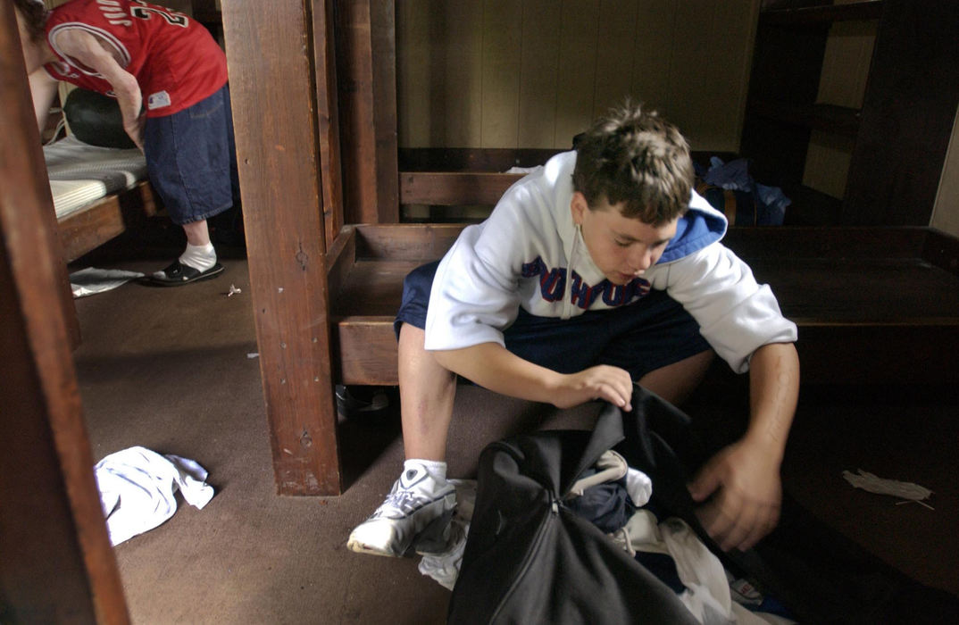 First Place, Feature Picture Story - Gus Chan / The Plain DealerLouie Polgar, 13, (right) and Chad Parker, 17, pack their belongings on the final day at Camp Christopher, August 29, 2004. 