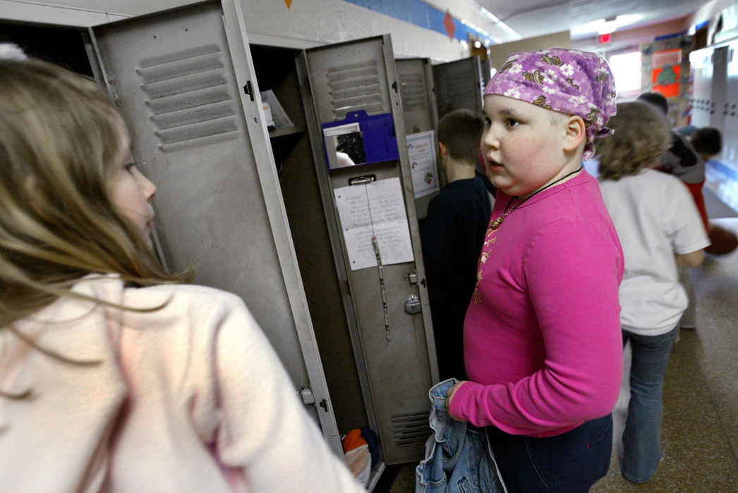 Second Place, Feature Picture Story - Fred Squillante / The Columbus DispatchAbbie (right) and classmate Ellen Leslie put their coats back in their lockers after recess at Ridgedale Elementary School. Abbie was visiting her class for the day.