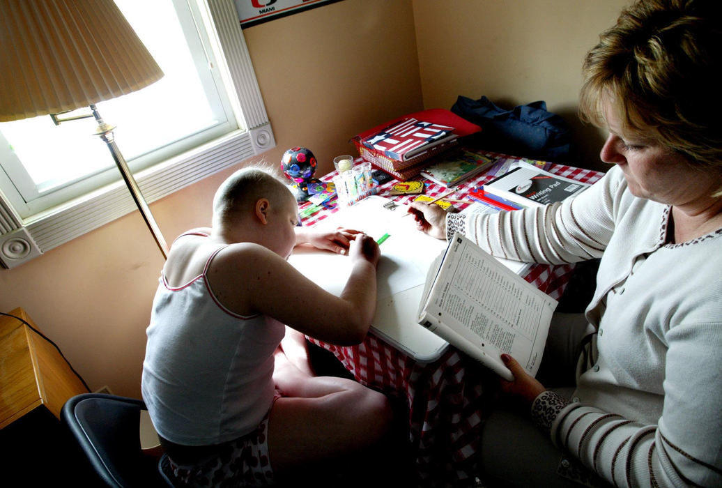 Second Place, Feature Picture Story - Fred Squillante / The Columbus DispatchCheryl Kuzio (right) tutors Abbie in Abbie's bedroom. Kuzio was Abbie's 3rd-grade teacher and now comes to the Dunn home for her 4th-grade studies. 