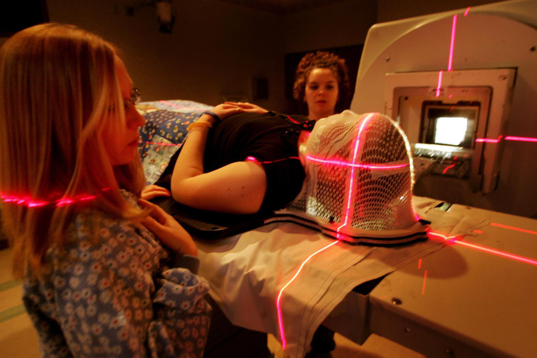 Second Place, Feature Picture Story - Fred Squillante / The Columbus DispatchRadiation therapists Georgia Pick (left) and Valerie Niederkohr prepare Abbie for a radiation treatment at James Cancer Hospital. Abbie is wearing a mask which keeps her head immobilized during the treatment.