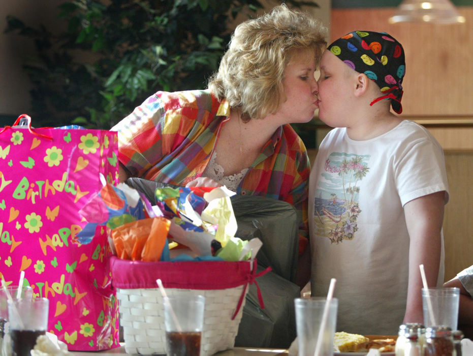 Second Place, Feature Picture Story - Fred Squillante / The Columbus DispatchAbbie gets a kiss from her mom, Sherrie, as they pack up Abbie's birthday gifts  after her party at Godfather's Pizza in Marion. Abbie turned 11. 