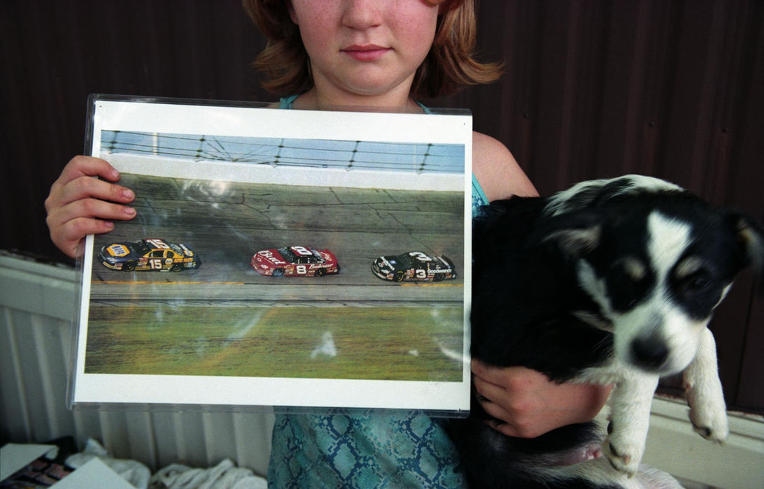 Third Place, Feature Picture Story - Samantha Reinders / Ohio University"He's my favorite," says Christine, holding her yard sale purchase: a laminated poster of Dale Earnhardt's last lap before his death.