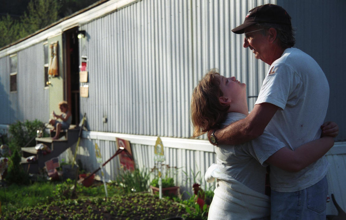 Third Place, Feature Picture Story - Samantha Reinders / Ohio UniversityBrittany hugs her grandfather and begs for $2 to spend at a neighbouring yard sale.
