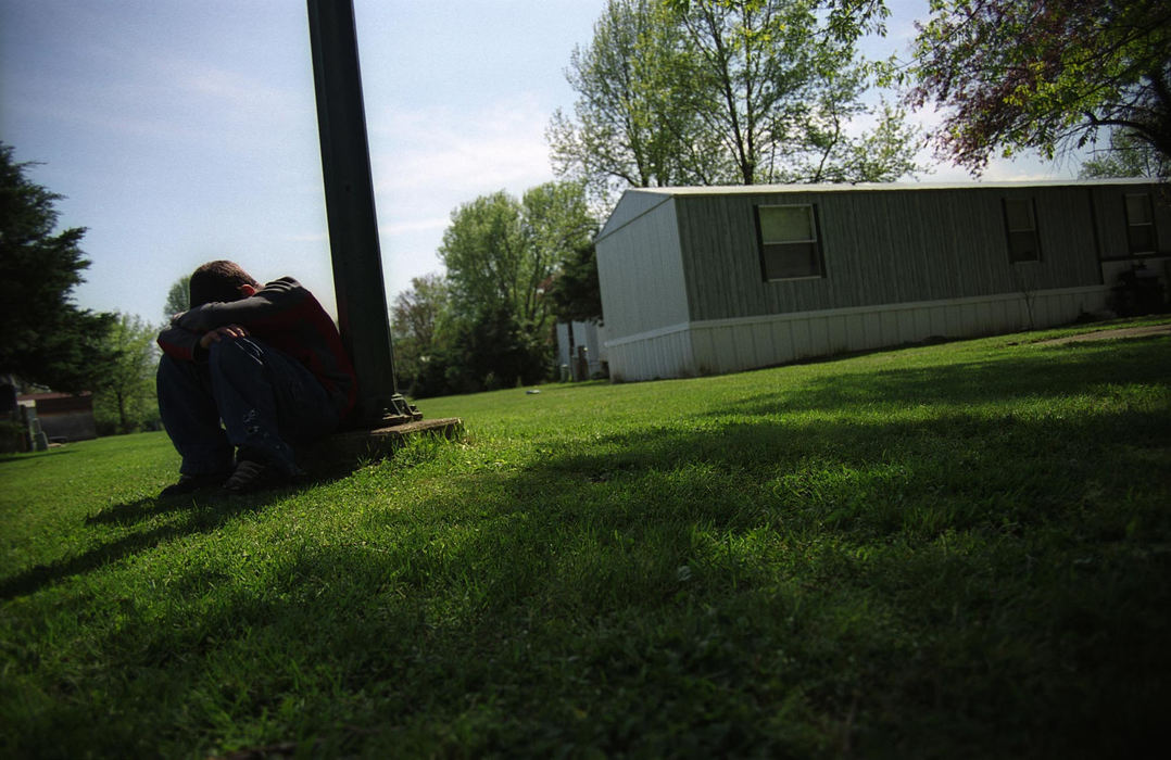 Third Place, Feature Picture Story - Samantha Reinders / Ohio UniversityChris bows his dizzy head after chewing tobacco. "It makes me feel spacey ... I even do it at school," he says. Just weeks after this photograph was taken Chris decided to drop out of school all together. 