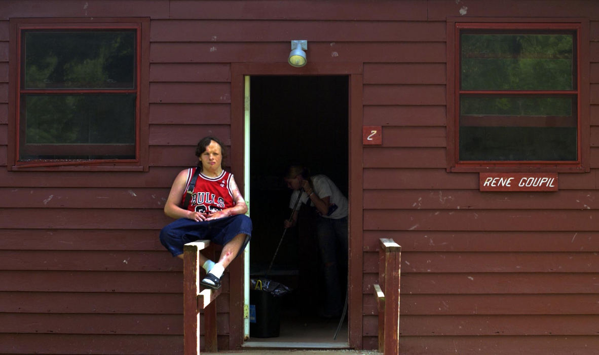 First Place, Feature Picture Story - Gus Chan / The Plain DealerChad Parker, 17, daydreams while a camp counselor finishes sweeping out the cabin at Camp Christopher, August 29, 2004. 