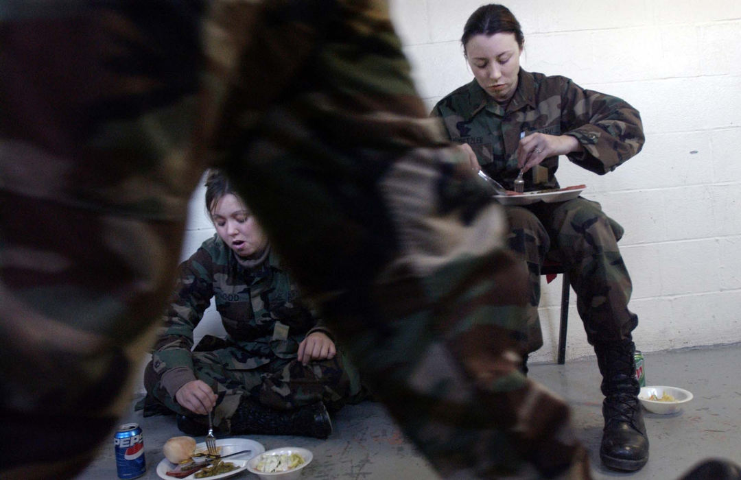 Award of Excellence, Feature Picture Story - Eustacio Humphrey / The Plain DealerSpc. Kristin Kretzler (right) says she is not a fan of military food. However, she does take advantage of the lunch break during her weekend drill assignment on a Saturday afternoon. Next to her is Spc. Tiffani Good of Akron. Kretzler is with the Ohio Army National Guard 1484th Transportation Company. The company will train and prepare to go to the Middle East where they will receive their next assignment to fight in the war on terrorism.