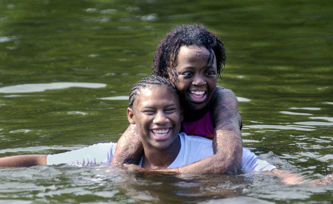 First Place, Feature Picture Story - Gus Chan / The Plain DealerCasarra Muhammad, 16, gets a ride from Olivia Peterson, 17, at Camp Christopher, August 27, 2004. 