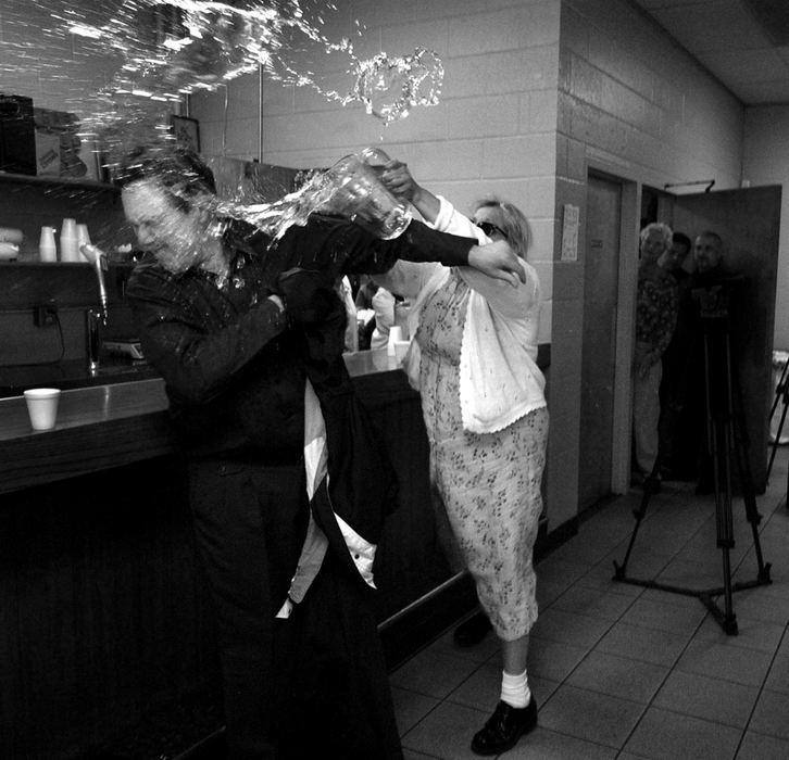 Award of Excellence, General News - Jeremy Wadsworth / The BladeRick Napierala a supporter of Father Gerald Robinson is doused with water by Paulina Garcia Cleveland at the Scott Park Banquet Room during a celebration of Robinson's release.  Cleveland came in support of sister Margaret Ann Pahl who was allegedly murdered by Robinson in 1980. 