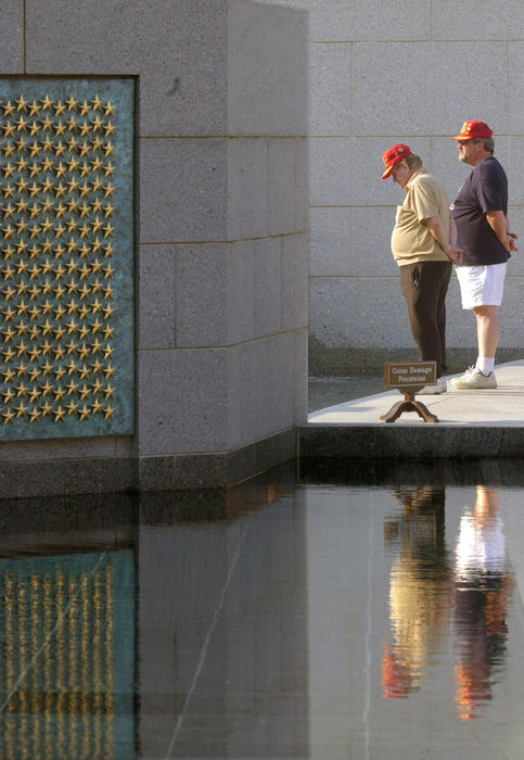 First Place, News Picture Story - Joshua Gunter / The Plain DealerVeterans of different wars, A father and son take a moment by themselves at the World War II War Memorial, May 28, 2004 in Washington D.C. 